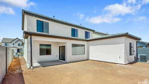 Back of house with stucco siding, a patio, and fence