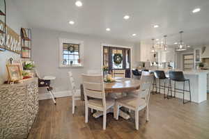 Dining room featuring dark wood-style floors, recessed lighting, and a healthy amount of sunlight