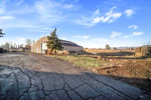 Exterior space with a detached garage, an outbuilding, and an outdoor structure