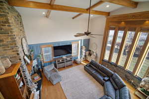 Living area featuring a ceiling fan, recessed lighting, wood finished floors, and vaulted ceiling with beams