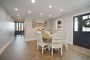 Dining space with recessed lighting, baseboards, and wood finished floors