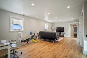 Home office featuring recessed lighting, visible vents, baseboards, and light wood-style flooring