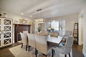 Dining space with dark wood-style floors, recessed lighting, and baseboards