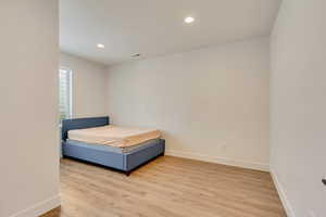 Unfurnished bedroom with visible vents, recessed lighting, baseboards, and light wood-style floors
