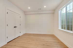 Unfurnished bedroom with recessed lighting, visible vents, baseboards, and light wood finished floors