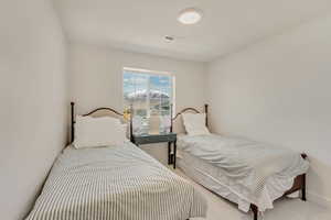 Carpeted bedroom with visible vents and baseboards