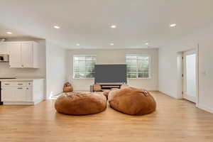 Sitting room with recessed lighting, light wood-type flooring, and baseboards