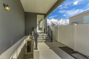 View of patio featuring a mountain view and fence