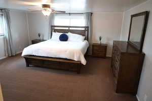 Bedroom with a ceiling fan, carpet, and baseboards