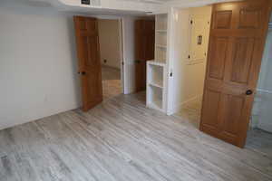Bedroom with visible vents, baseboards, and light wood-style floors