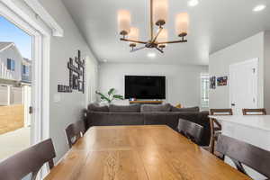 Dining area featuring a notable chandelier and recessed lighting