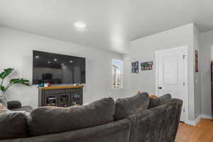 Living room featuring baseboards and light wood-type flooring