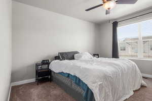 Bedroom featuring carpet, baseboards, and ceiling fan