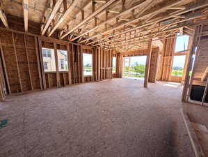 Great room with slider doors to covered porch and waterfront lot