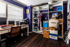 Office area featuring crown molding and wood finished floors
