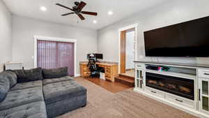 Living area featuring a ceiling fan, carpet flooring, and recessed lighting