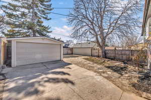 Detached garage featuring fence