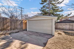 Detached garage featuring fence