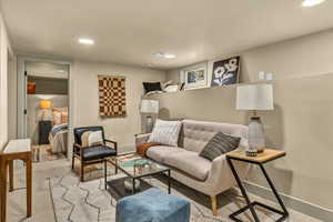 Living room featuring recessed lighting, visible vents, and baseboards