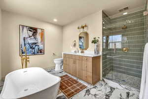 Bathroom with visible vents, marble finish floor, a shower stall, and vanity