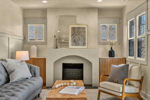 Living area featuring recessed lighting, a fireplace, and a decorative wall