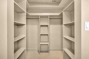 Spacious closet with visible vents and carpet floors