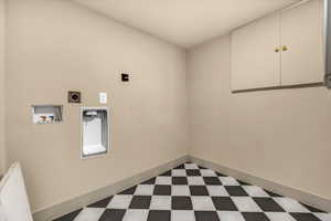 Laundry room with hookup for a washing machine, baseboards, laundry area, electric dryer hookup, and dark floors