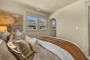 Bedroom with visible vents and arched walkways