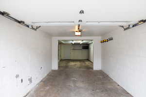 Garage with concrete block wall and a garage door opener