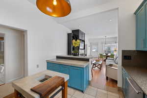 Kitchen with blue cabinets, recessed lighting, and light tile patterned floors