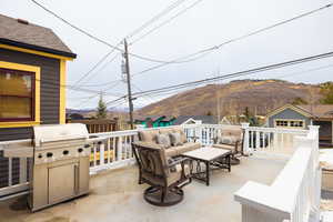 View of patio with outdoor lounge area, a mountain view, and a grill