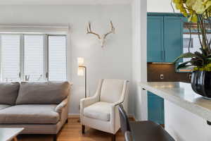 Living area with baseboards and light wood-type flooring