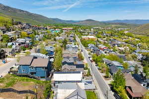 Aerial perspective of suburban area featuring a mountain backdrop