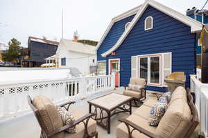 View of patio with an outdoor living space and fence