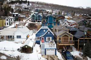 Snowy aerial view featuring a residential view