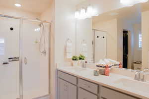 Ensuite bathroom with double vanity, shower, & soft closing cabinets
