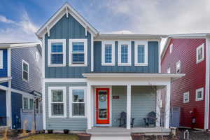 View of front of home featuring covered porch and board and batten siding