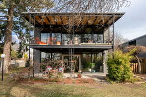 Back of property with a balcony and a patio area