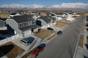 Birds eye view of property with a mountain view and a residential view