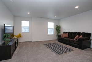 Living area featuring carpet flooring, recessed lighting, and plenty of natural light