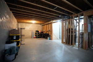 Unfinished below grade area featuring stairway
