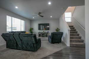 Living area featuring stairway, recessed lighting, baseboards, and ceiling fan