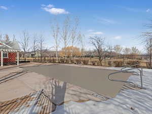 View of swimming pool with a patio and fence