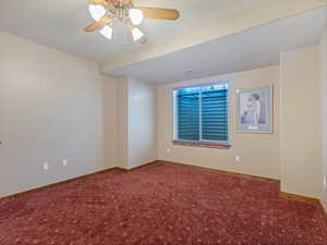 Empty room featuring baseboards, ceiling fan, and carpet flooring