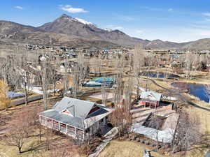 Drone / aerial view featuring a water and mountain view