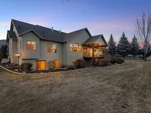 View of home's exterior featuring a lawn, board and batten siding, and a shingled roof