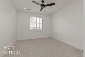 Unfurnished room featuring visible vents, baseboards, carpet, and a ceiling fan