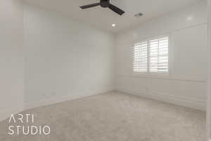 Carpeted spare room featuring visible vents, recessed lighting, baseboards, and ceiling fan