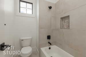 Full bathroom featuring tile patterned flooring, shower / tub combination, toilet, and baseboards
