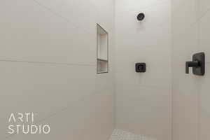 Bathroom featuring a tile shower